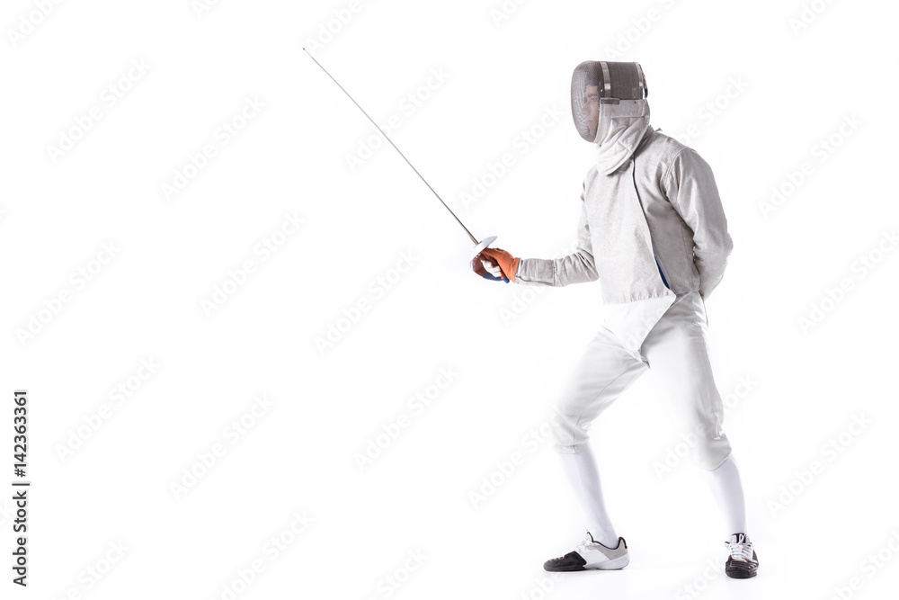 Side view of man wearing fencing suit practicing with sword