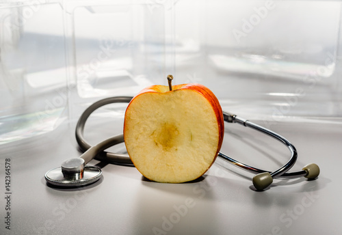 Stethoscope on a general plan and a fragment of a large apple.
