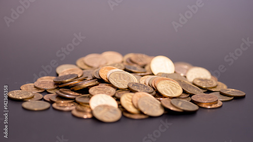 a scattering of coins on a black background