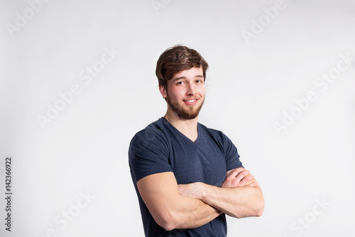 Handsome fitness man in gray t-shirt, studio shot.