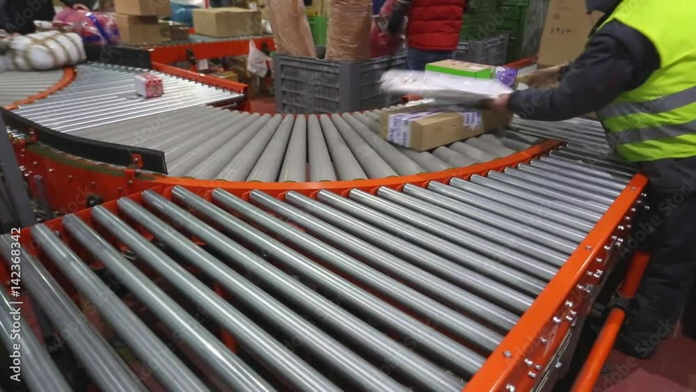 Sorting and Shipping Parcels at Conveyer Rollers in Distribution Warehouse