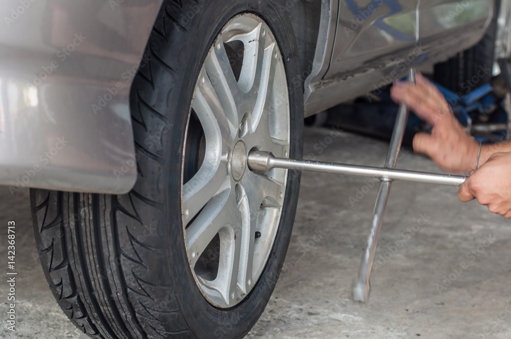 Unidentified worker change tire, movement action. Unidentified worker change tire, movement action.