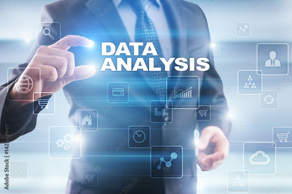 Businessman selecting data analysis on virtual screen.