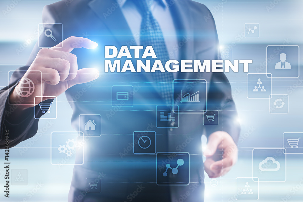 Businessman selecting data management on virtual screen. Businessman selecting data management on virtual screen.