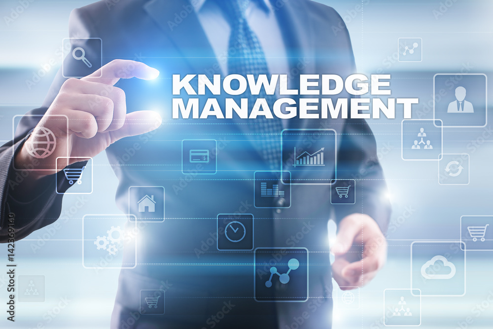 Businessman selecting knowledge management on virtual screen. Businessman selecting knowledge management on virtual screen.