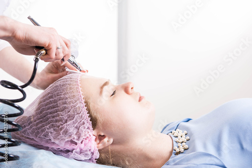 Cosmetologist performs the rejuvenation procedure