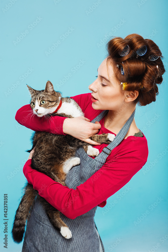 Woman and cat pose for picture together while cleaning Woman and cat pose for picture together while cleaning