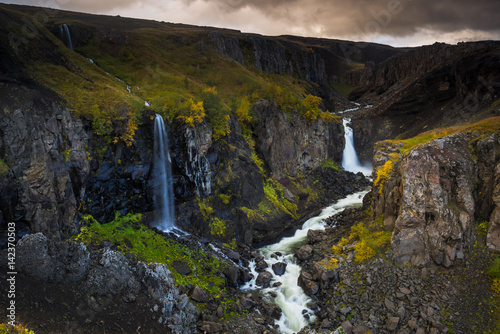Cloudy sunset over the cliff with stunning waterfall at Hengifoss  Iceland