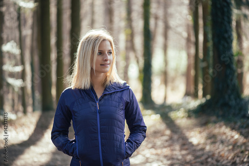 Fit woman standing in forest, close up. © Laszlo