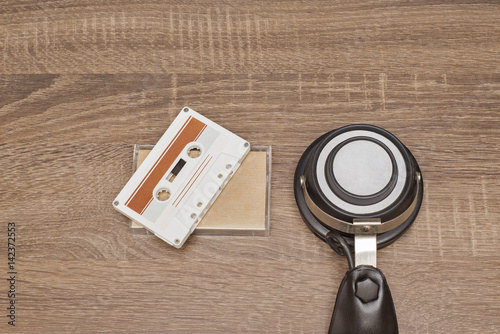 Wallpaper Mural Retro audio tape and headphones on brown wooden background Torontodigital.ca