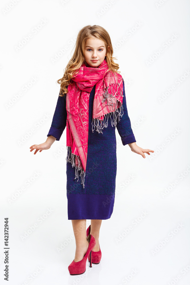 Fototapeta premium Charming little lady in sleeve midi dress and pink scarf.