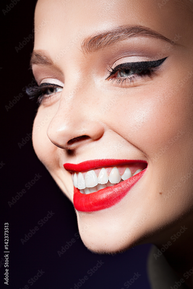 pretty girl with red lips and professional make up with eye arrow and strong face
