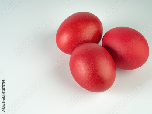 Three red easter eggs on white background