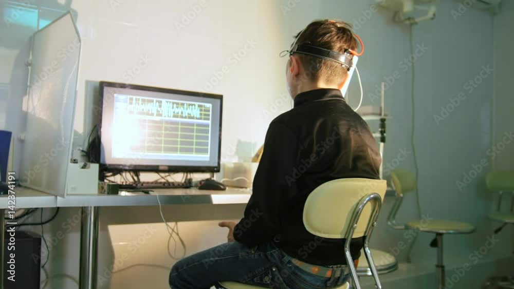 Child checks vision with the stereo video virtual reality glasses - ophthalmology clinic Child checks vision with the stereo video virtual reality glasses - ophthalmology clinic