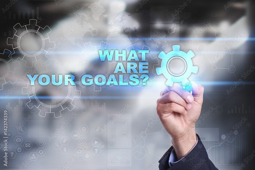 Businessman is drawing on virtual screen. what are your goals concept. Businessman is drawing on virtual screen. what are your goals concept.