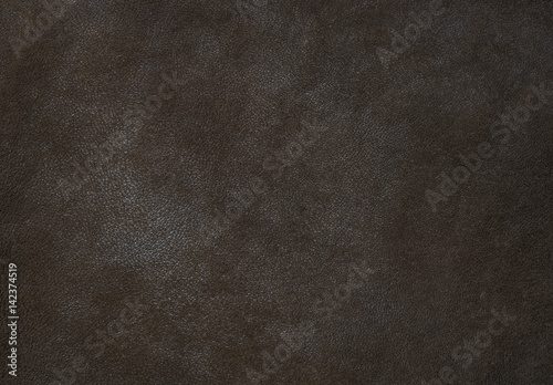 Dark brown leather texture close up can be used as background.