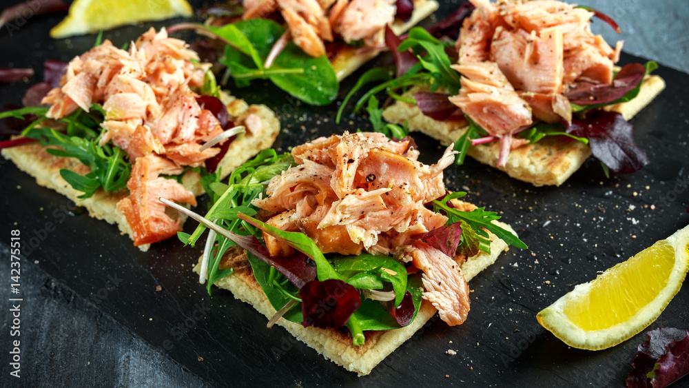 Smoked salmon flakes on salad bed and irish potato slims snacks, appetizers Smoked salmon flakes on salad bed and irish potato slims snacks, appetizers