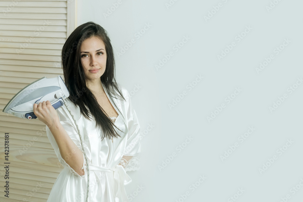 pretty girl or housewife with iron in hand pretty girl or housewife with iron in hand
