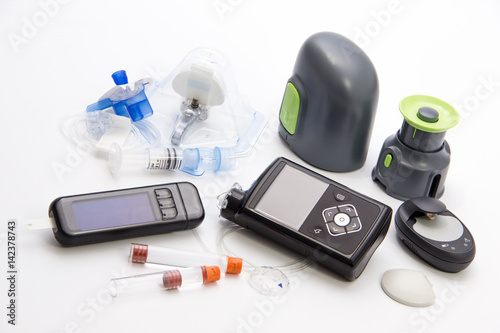 Diabetic items - Diabetes care, concept, test, monitor, background: Education about items to control diabetes: New modern Sensor-Augmented insulin pump, blood sugar meter and glucose sensor with set