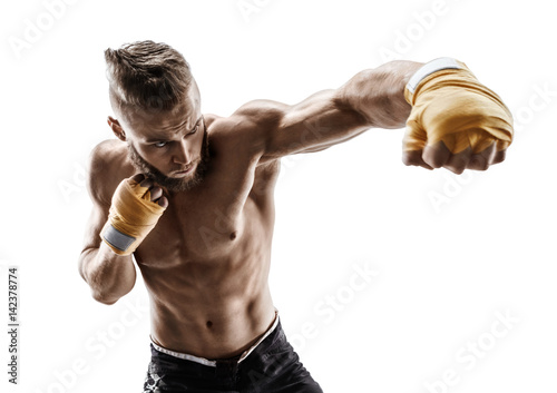 Athletic boxer throwing a fierce and powerful punch. Photo of muscular man isolated on white background. Strength and motivation. photo