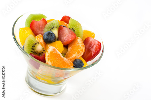 Fruit salad in crystal bowl isolated on white background

