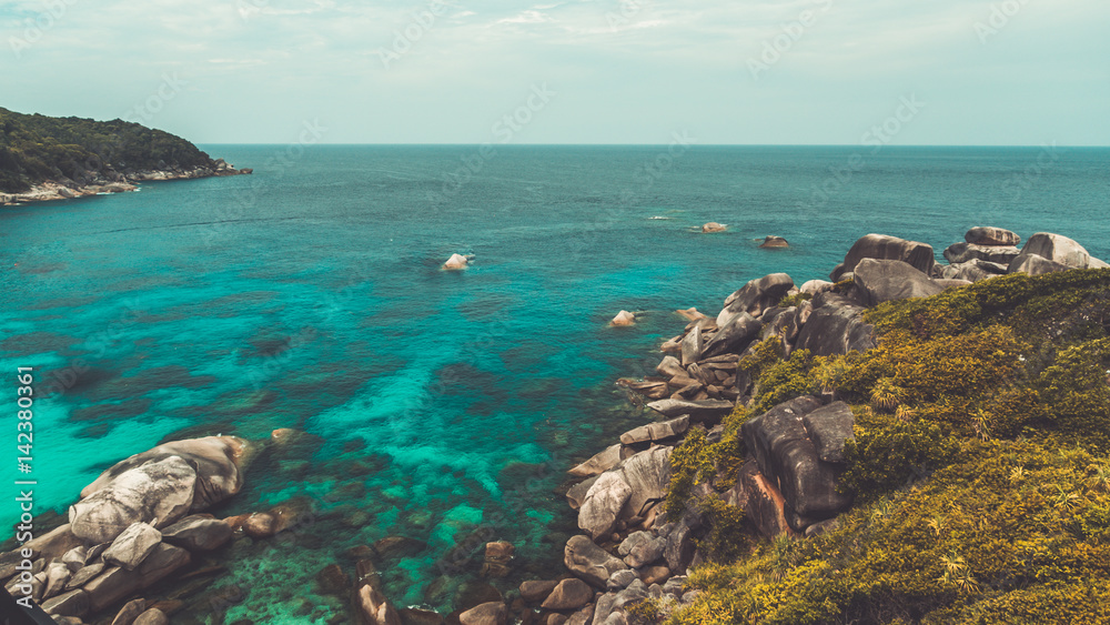Turquoise sea stone cliff.
