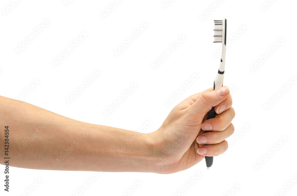 Obraz premium woman hand holding toothbrush.