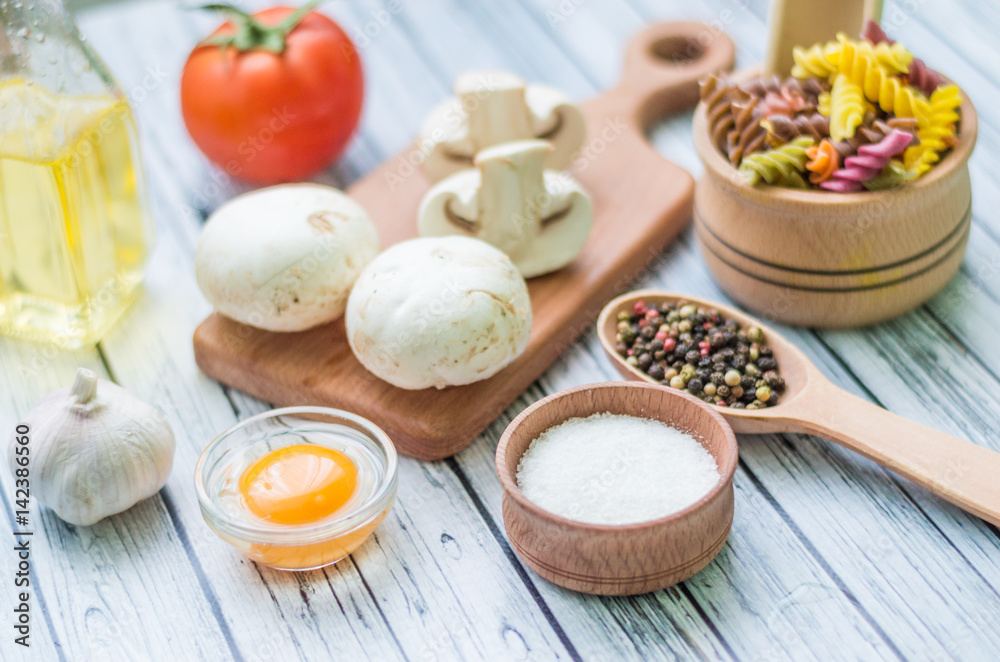 Still life with pasta ingredients on the wooden background Still life with pasta ingredients on the wooden background