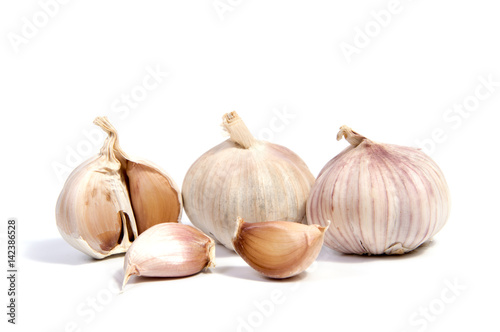 Fresh organic garlic and cutted garlic clove isolated on white background