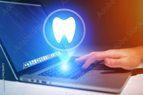 Concept of making an appointement with a dentist on internet - technology concept photo