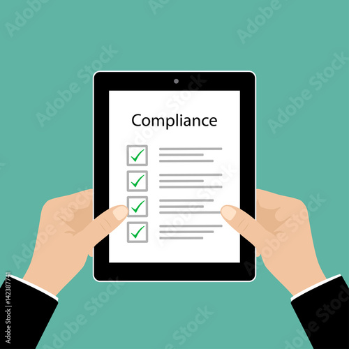 Business cocept. In Compliance Graphic with Tablet, businessman hand and tick marks