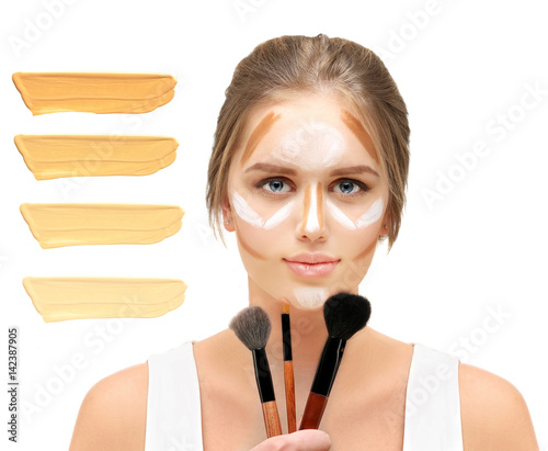 Putting makeup  Contouring.Make up woman face..Foundation on white background