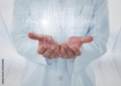 Doctor with white graph and flare in hands against blurry window