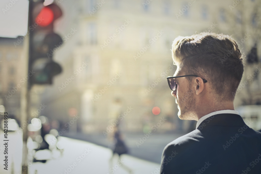 Young businessman waiting to cross the street Young businessman waiting to cross the street