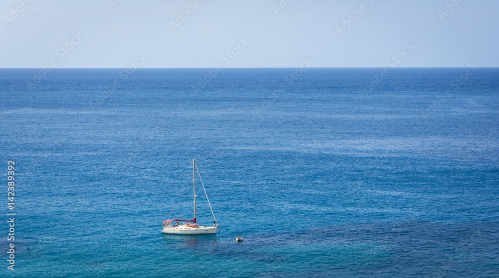 Sailing boat on blue mediterranean water in Ibiza island