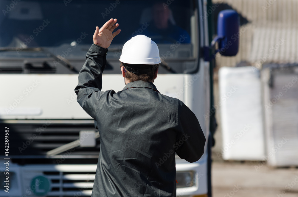 Worker in uniform overlooking work site Worker in uniform overlooking work site