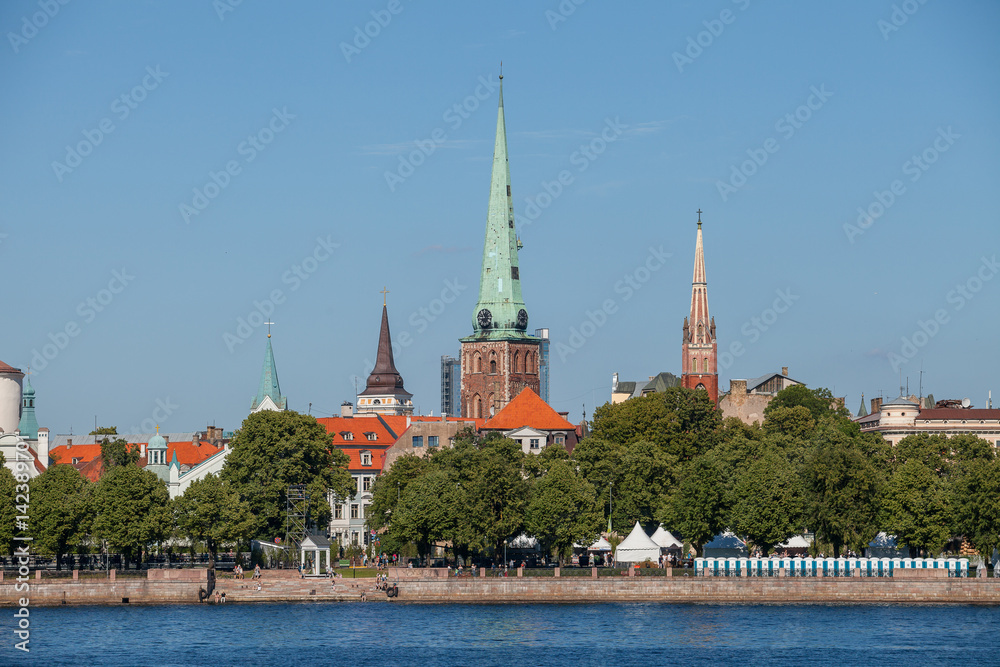 Summer day view on churches of Riga old town with Daugava river