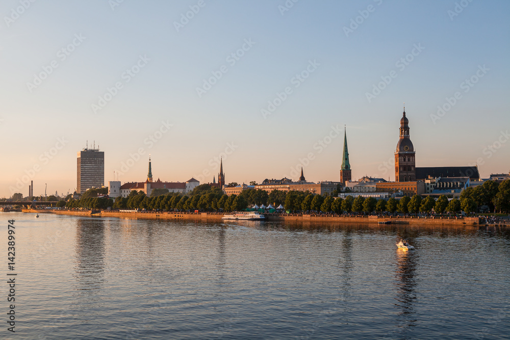 Old town of Riga summer sunset skyline with Daugava river