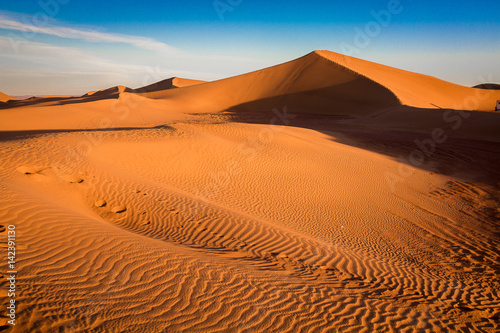 Sunrise over the dunes in the sahara with clear skies