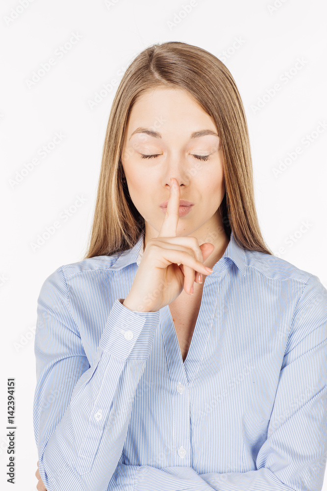 woman showing hand silence sign, asking someone to keep it quiet. human emotion expression and lifestyle concept. image on a white studio background. woman showing hand silence sign, asking someone to keep it quiet. human emotion expression and lifestyle concept. image on a white studio background.