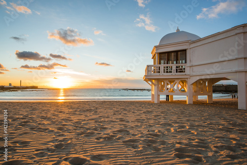 Romantic sunset at Cadiz beach with famous pier photo