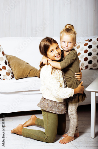 Photos little cute brunette girl at home interior happy smiling close up, lifestyle rea