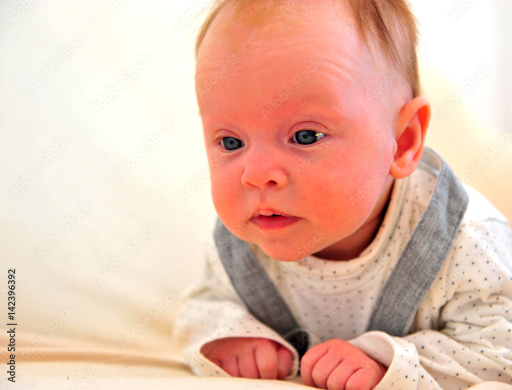Portrait of a baby lying on the bed
