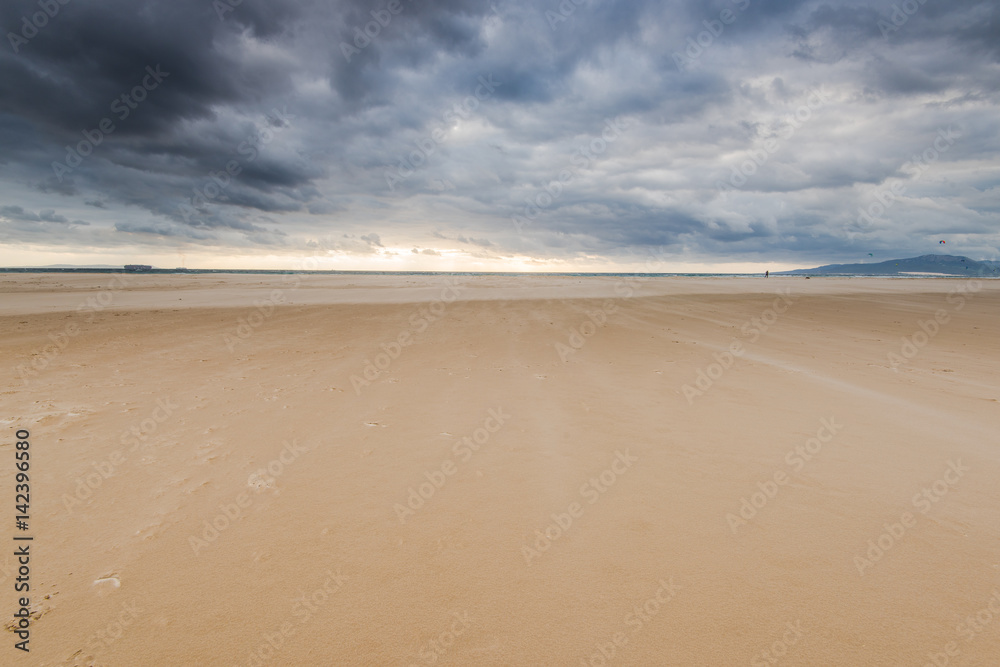 stormy dark clouds over sand beach