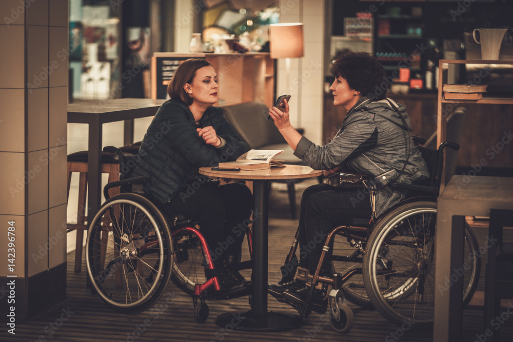 Two physically challenged women in a cafe Two physically challenged women in a cafe
