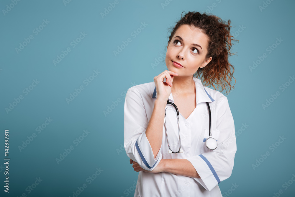 Portrait of a serious young nurse thinking and looking away Portrait of a serious young nurse thinking and looking away