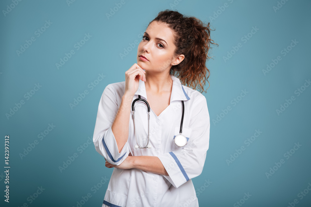 Portrait of a young nurse with stethoscope thiking about something Portrait of a young nurse with stethoscope thiking about something