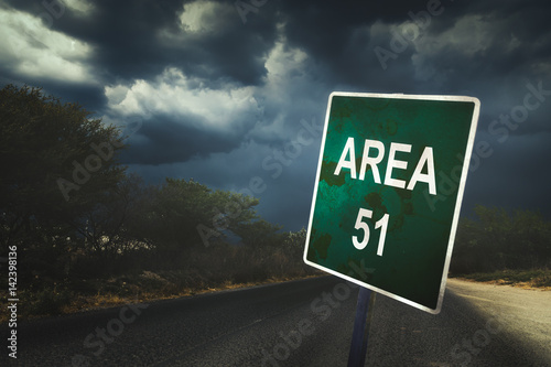 Area 51 sign on a road with dramatic lighting