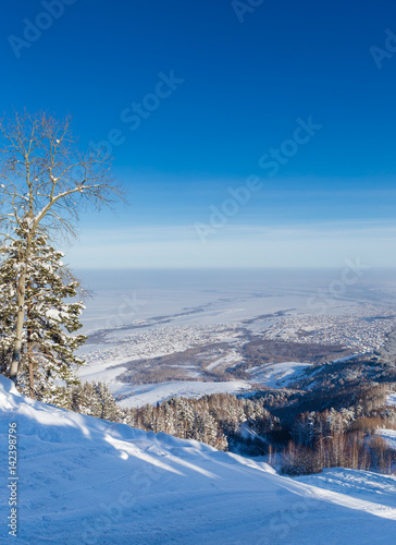 View from Tserkovka mountain to the resort town of Belokurikha in winter, Altai, Russia photo