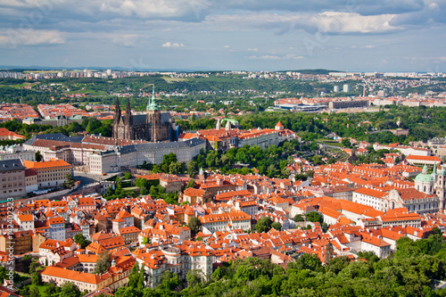 Aerial view of the city. St. Vitus Cathedral over old town red roofs. Prague, Czech Republic